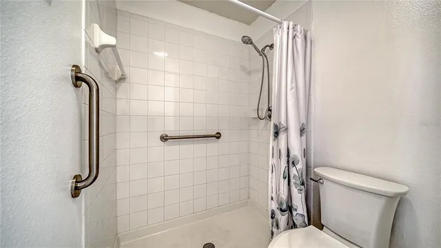 a bathroom with a toilet and shower