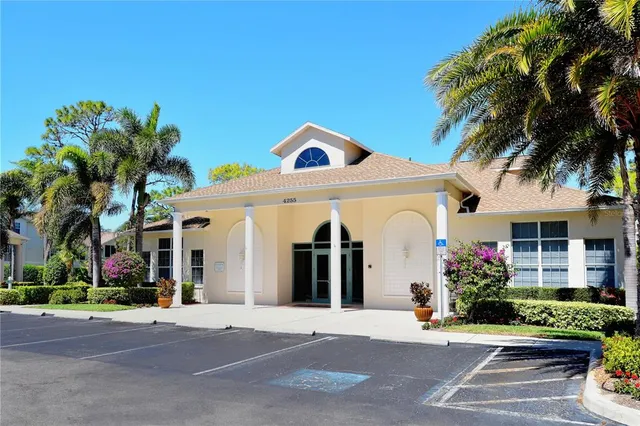 a living room with couches and kitchen view