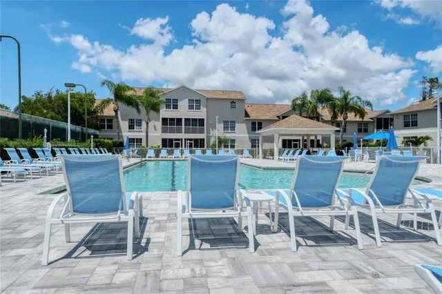 a view of a swimming pool with a patio and a garden
