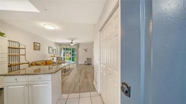 a spacious bathroom with a granite countertop sink and a mirror