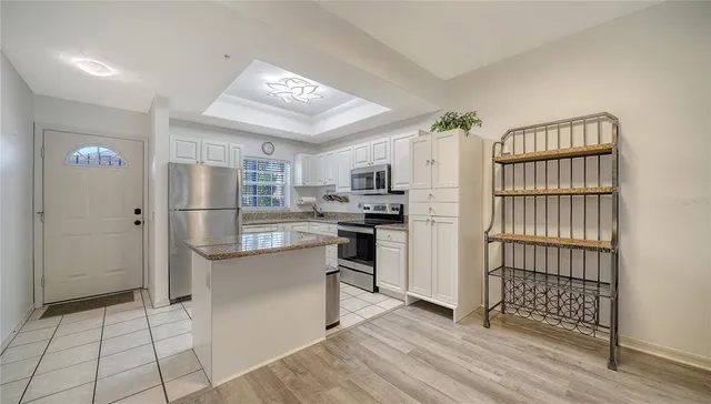 a kitchen with stainless steel appliances a refrigerator and a stove top oven