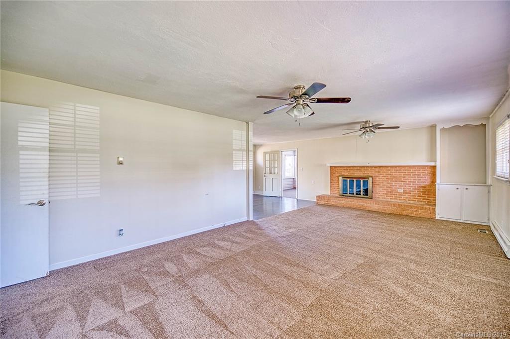 12001 Idlewild Road, Unit 7 Matthews, NC 28105 - Photo 11 of 29 a view of a livingroom with a ceiling fan window and closet