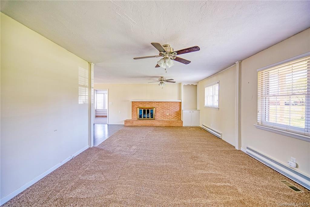 12001 Idlewild Road, Unit 7 Matthews, NC 28105 - Photo 12 of 29 a view of a livingroom with a ceiling fan and window