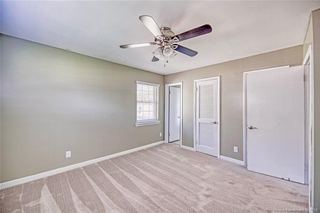 12001 Idlewild Road, Unit 7 Matthews, NC 28105 - Photo 18 of 29 a view of an empty room with a window