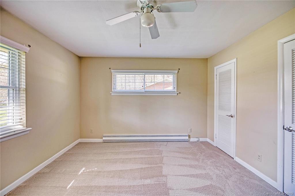12001 Idlewild Road, Unit 7 Matthews, NC 28105 - Photo 22 of 29 a view of an empty room with a window