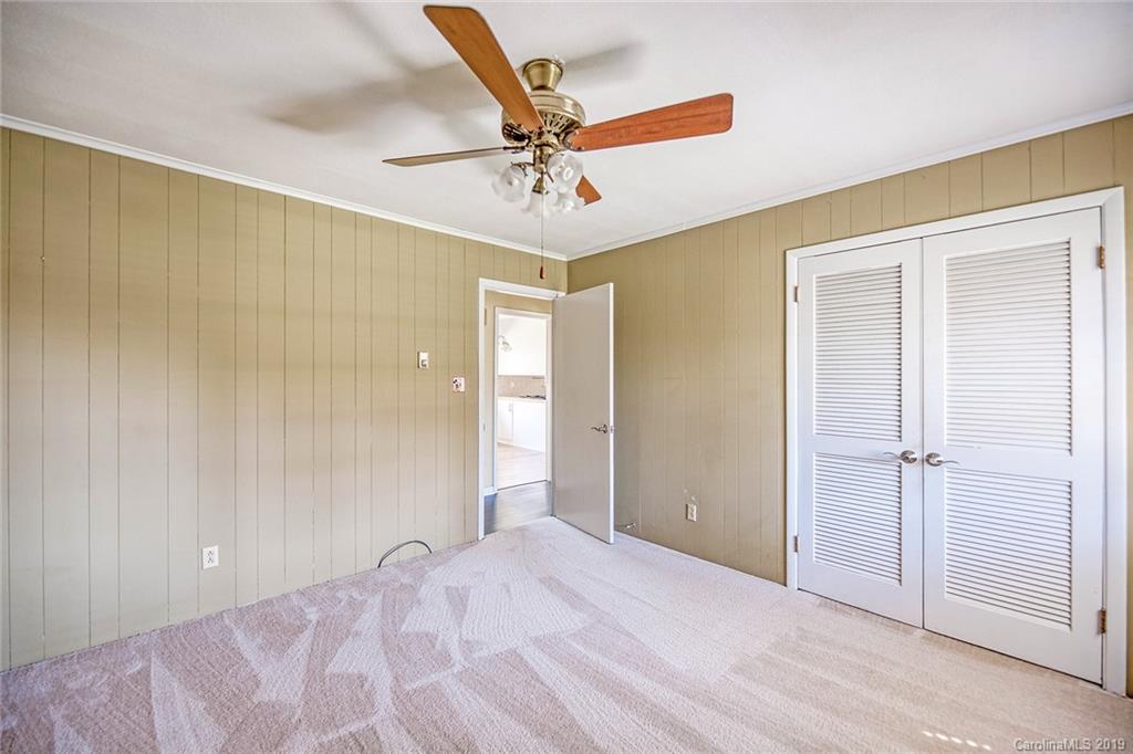 12001 Idlewild Road, Unit 7 Matthews, NC 28105 - Photo 25 of 29 a view of a livingroom with a chandelier fan