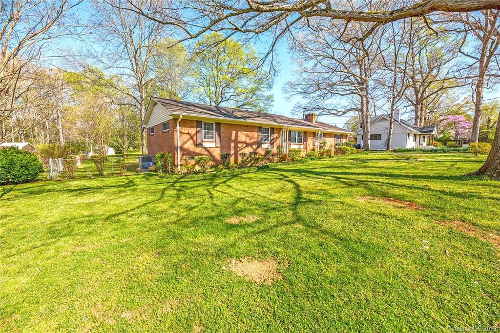 12001 Idlewild Road, Unit 7 Matthews, NC 28105 - Photo 27 of 29 a front view of a house with a big yard