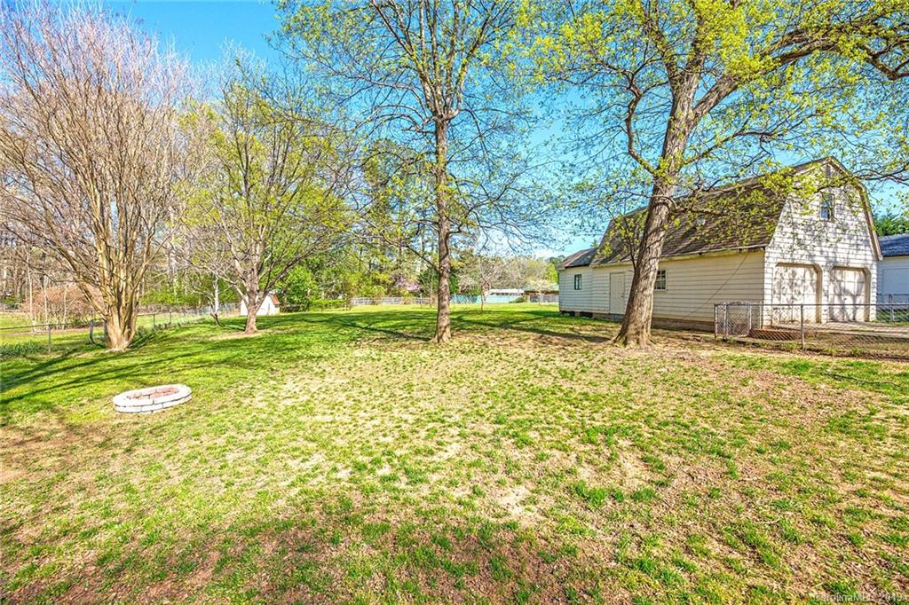 12001 Idlewild Road, Unit 7 Matthews, NC 28105 - Photo 29 of 29 a view of a house with a yard and tree s