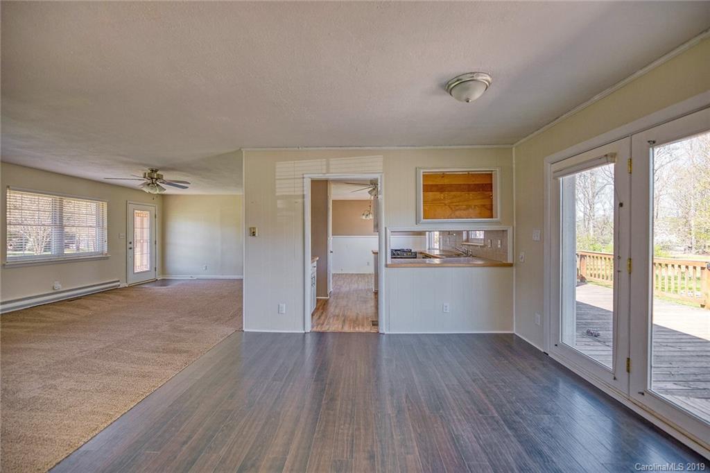 12001 Idlewild Road, Unit 7 Matthews, NC 28105 - Photo 6 of 29 a view of a big room with wooden floor and windows