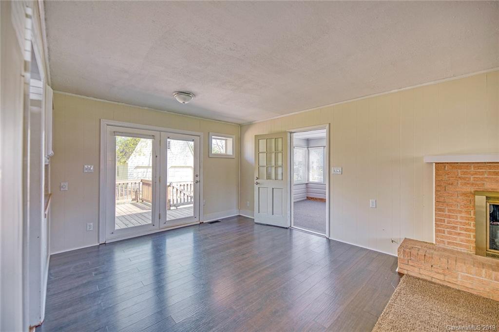 12001 Idlewild Road, Unit 7 Matthews, NC 28105 - Photo 8 of 29 an empty room with wooden floor and windows