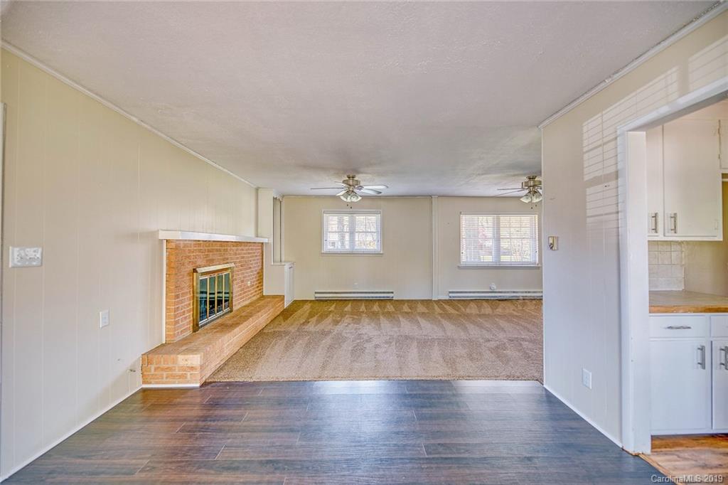 12001 Idlewild Road, Unit 7 Matthews, NC 28105 - Photo 9 of 29 an empty room with windows and fireplace