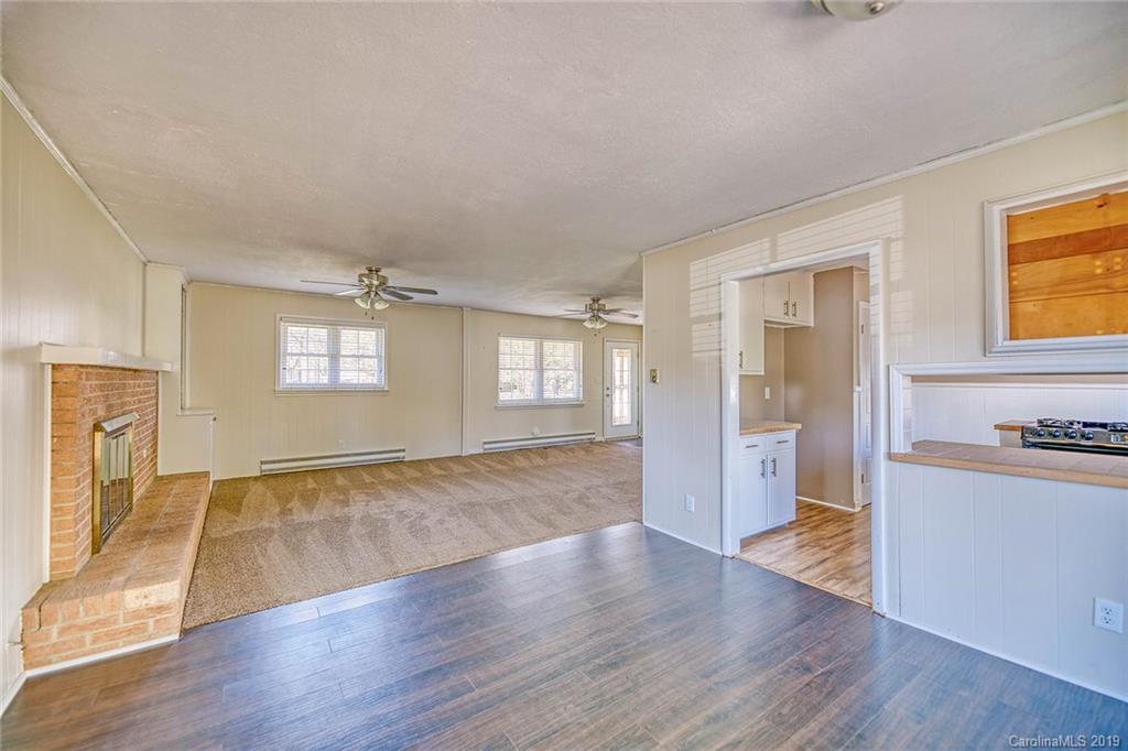 12001 Idlewild Road, Unit 7 Matthews, NC 28105 - Photo 10 of 29 a view of an empty room with a window and wooden floor