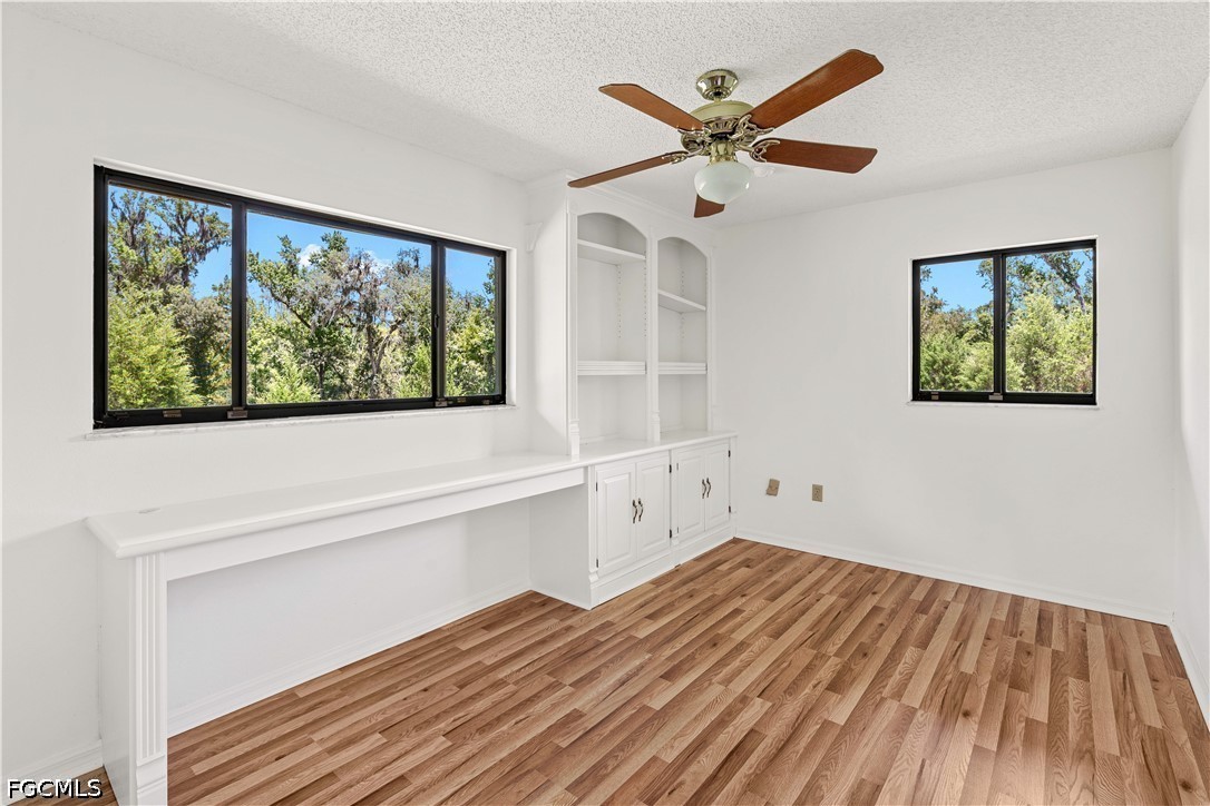27255 Hickory Hill Road Brooksville, FL 34602 - Photo 36 of 50 a view of empty room with wooden floor and ceiling fan