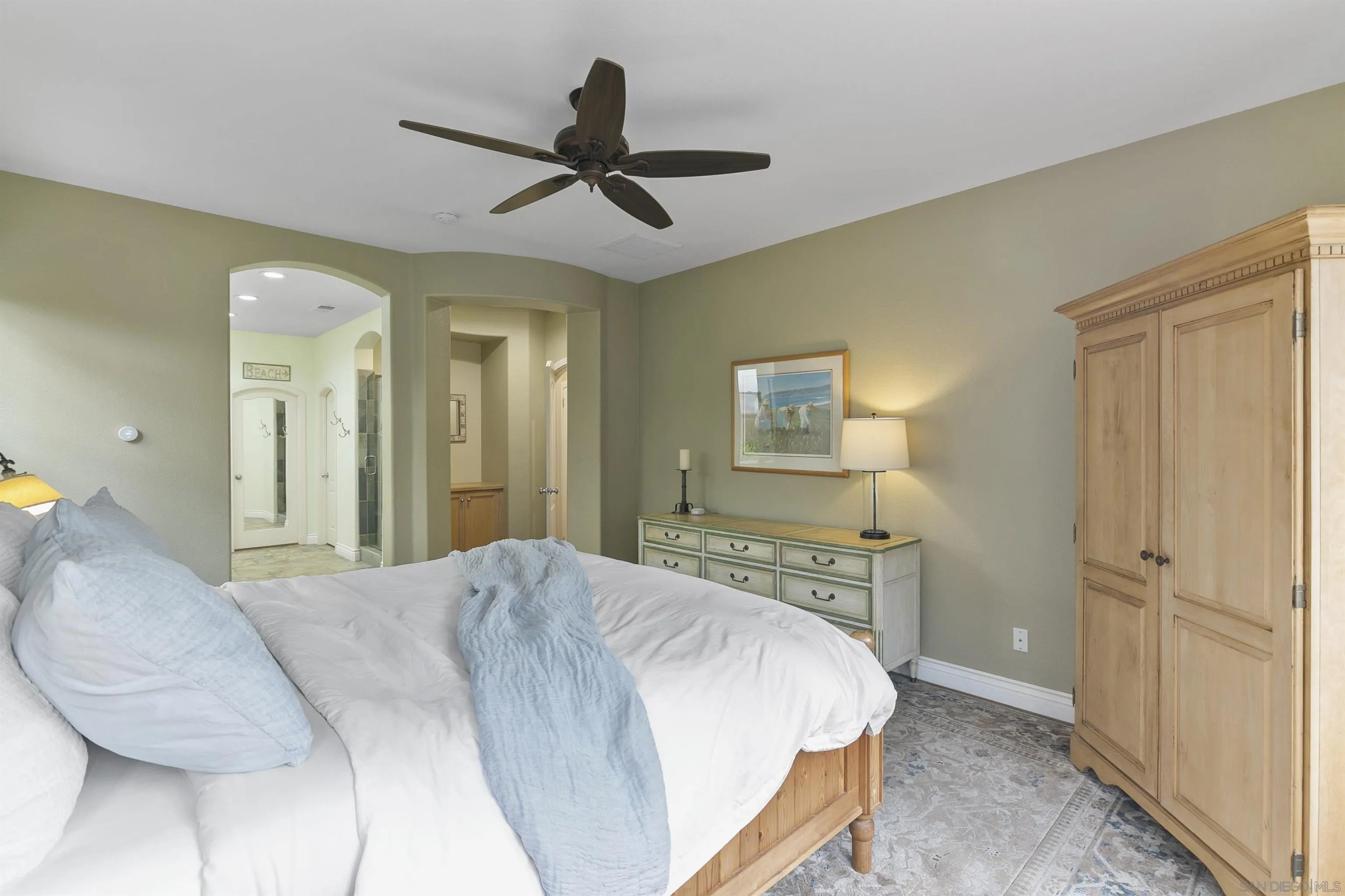 7451 Capstan Drive Carlsbad, CA 92011 - Photo 18 of 64 a bedroom with a bed and a chandelier