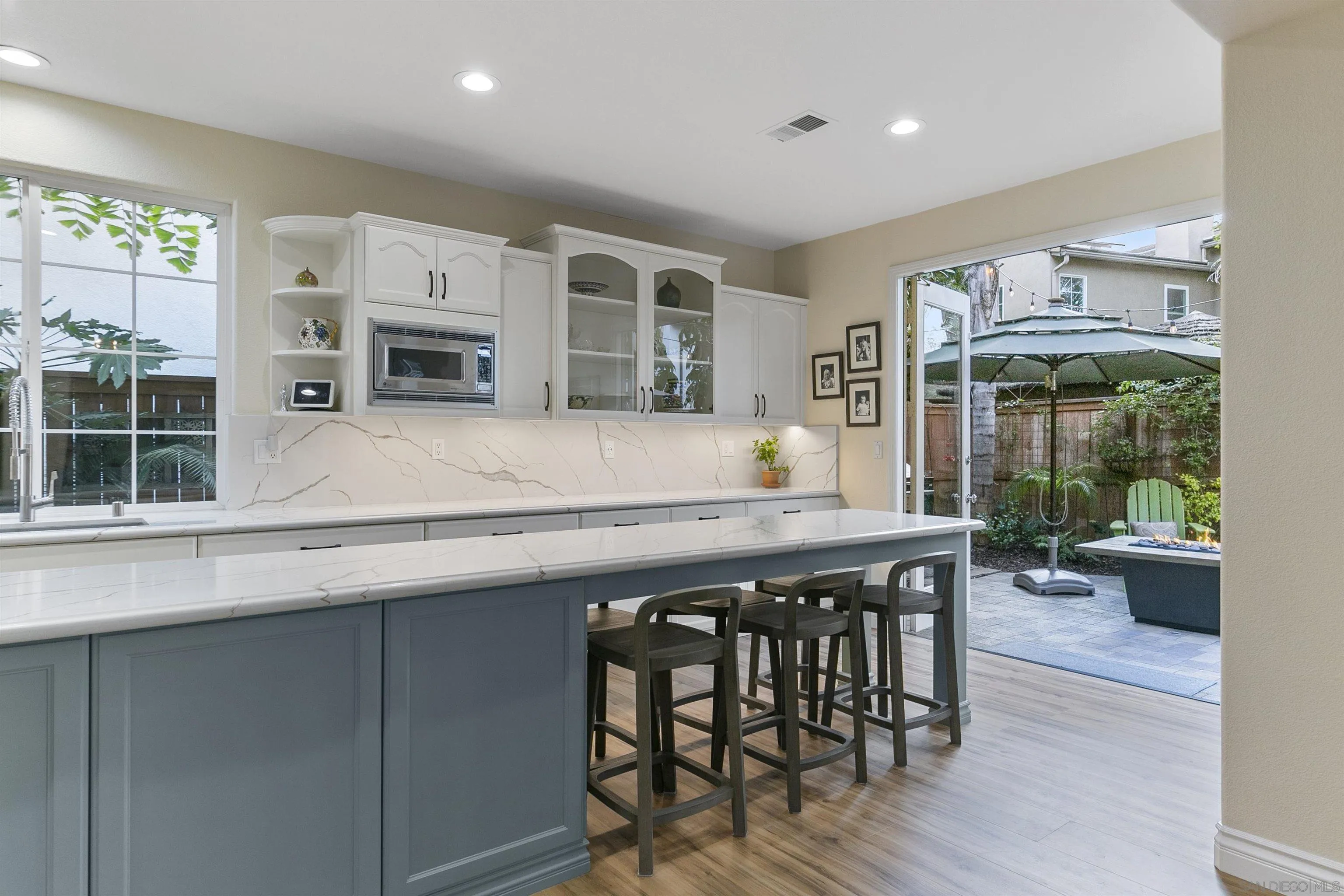 7451 Capstan Drive Carlsbad, CA 92011 - Photo 26 of 64 a kitchen with stainless steel appliances granite countertop a stove top oven a sink a dining table and chairs