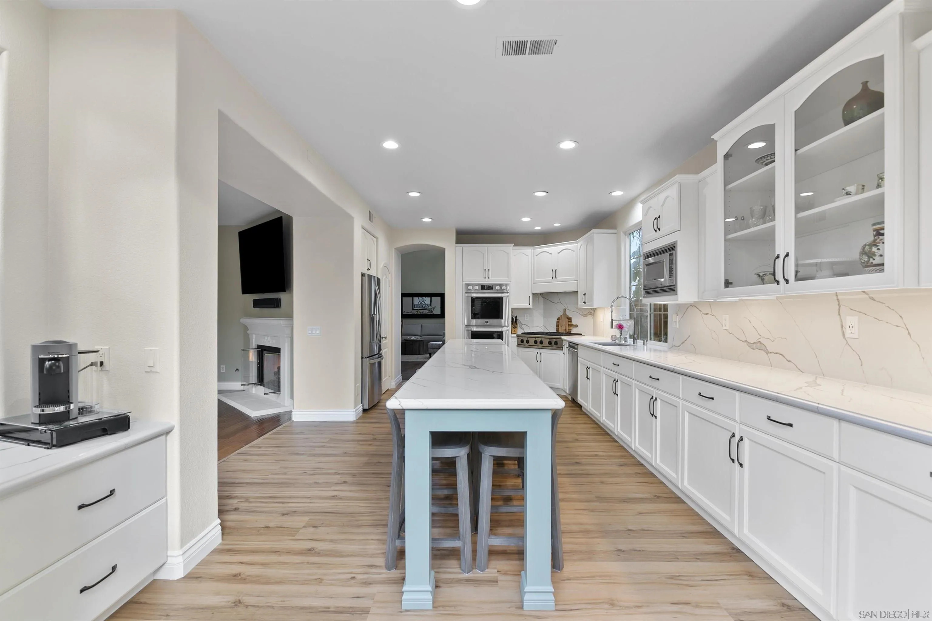7451 Capstan Drive Carlsbad, CA 92011 - Photo 28 of 64 a large kitchen with stainless steel appliances kitchen island granite countertop a large counter top and oven