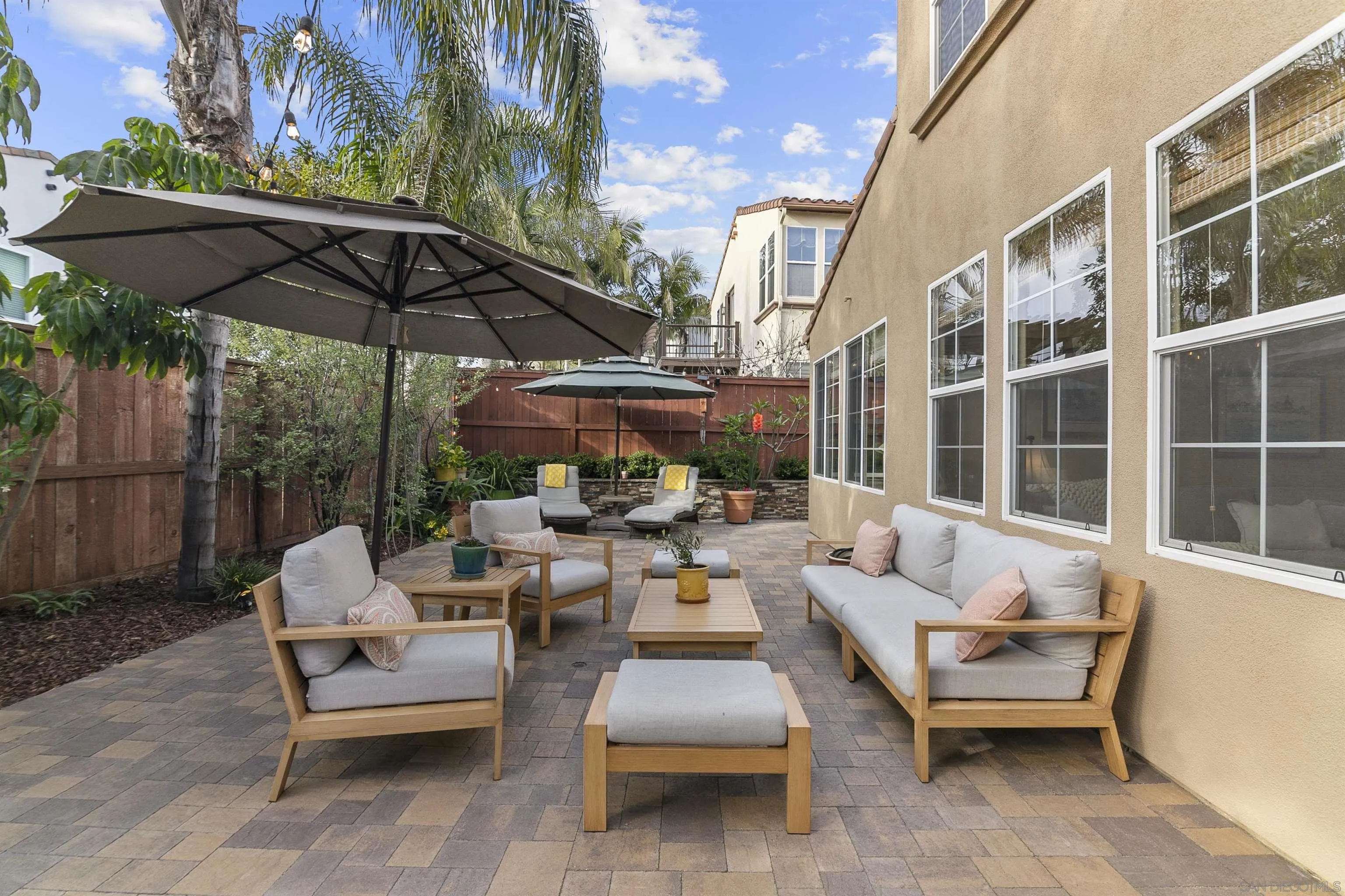 7451 Capstan Drive Carlsbad, CA 92011 - Photo 31 of 64 a patio with patio couch and umbrella