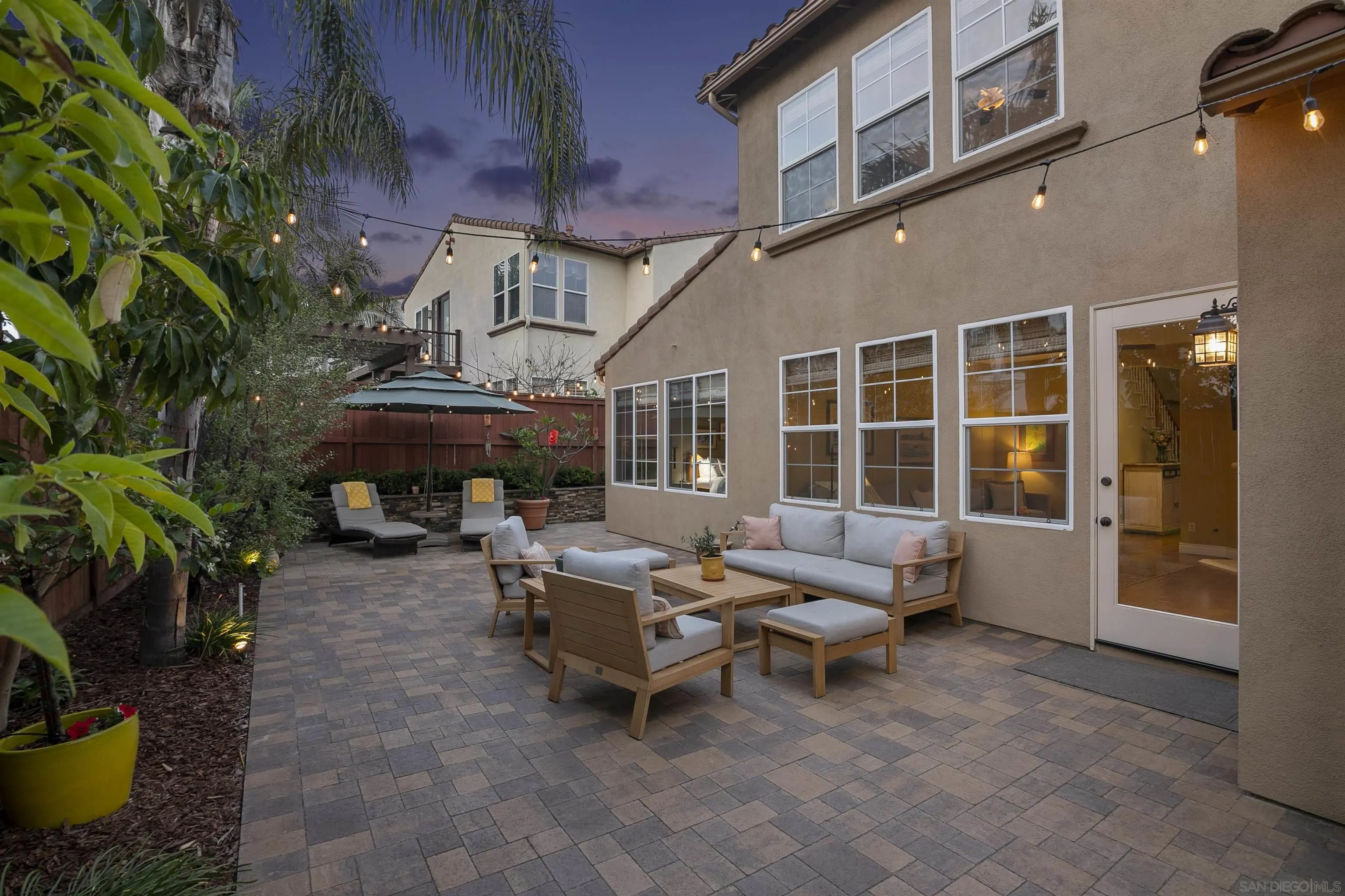 7451 Capstan Drive Carlsbad, CA 92011 - Photo 41 of 64 a view of a patio with a table and chairs under an umbrella