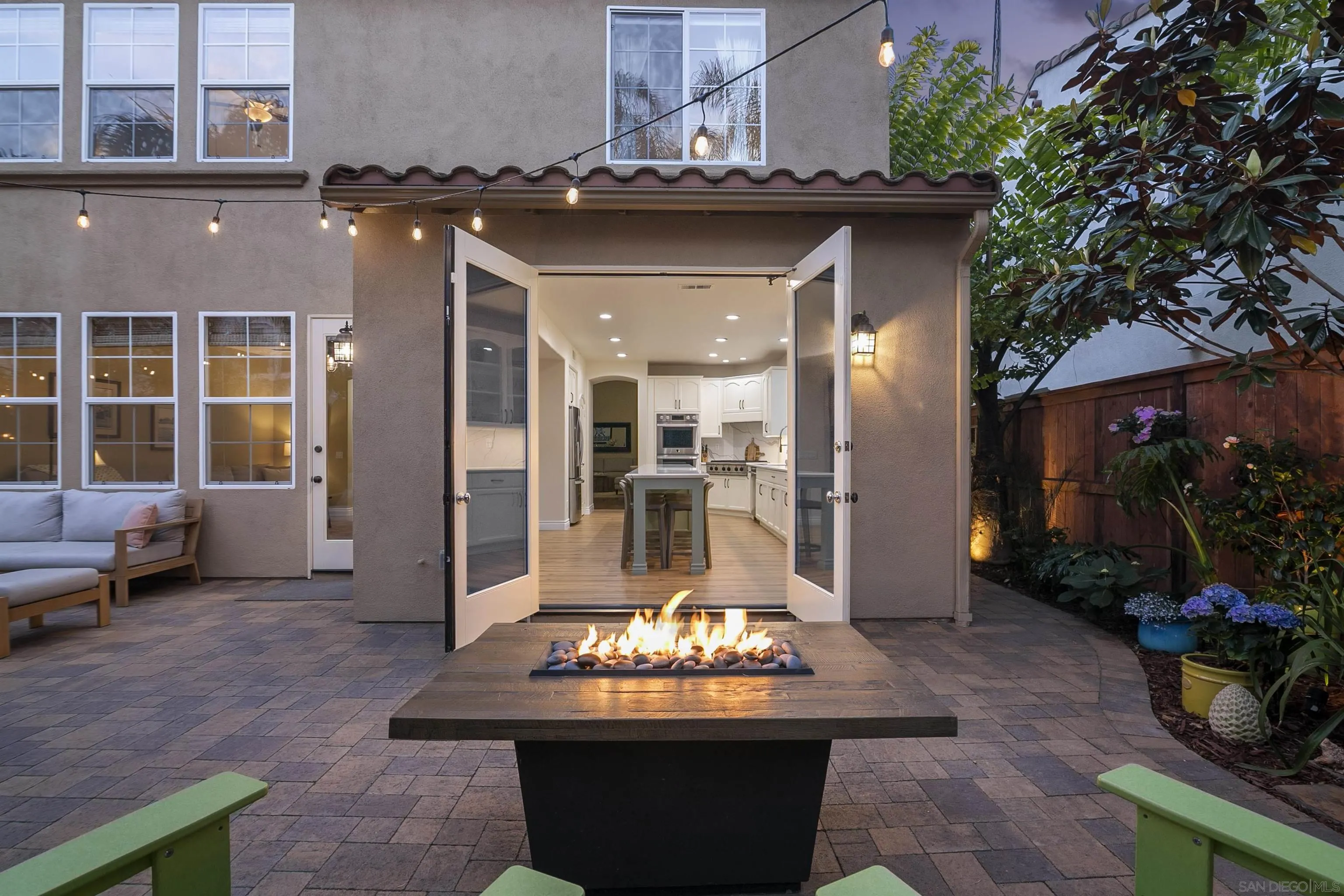 7451 Capstan Drive Carlsbad, CA 92011 - Photo 44 of 64 a view of a patio with dining table and chairs potted plants