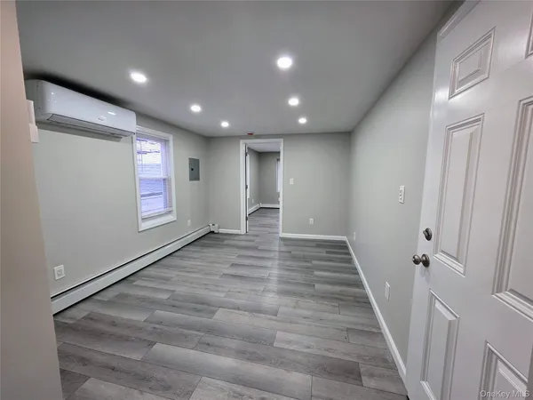 a view of hallway with stairs and wooden floor