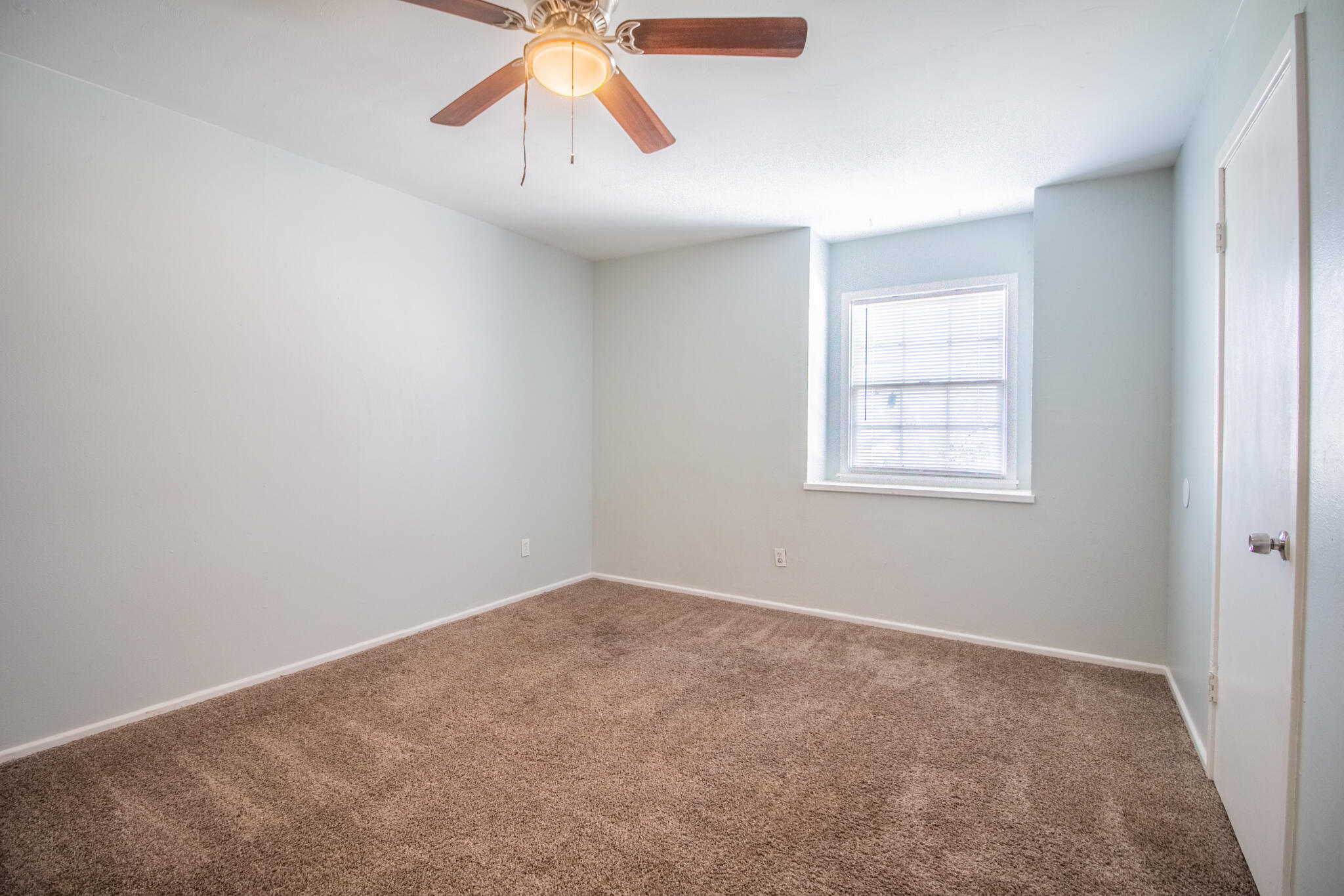 2101 49th Street Lubbock, TX 79412 - Photo 12 of 31 an empty room with windows and fan