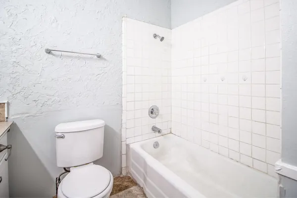 a bathroom with a toilet and bathtub