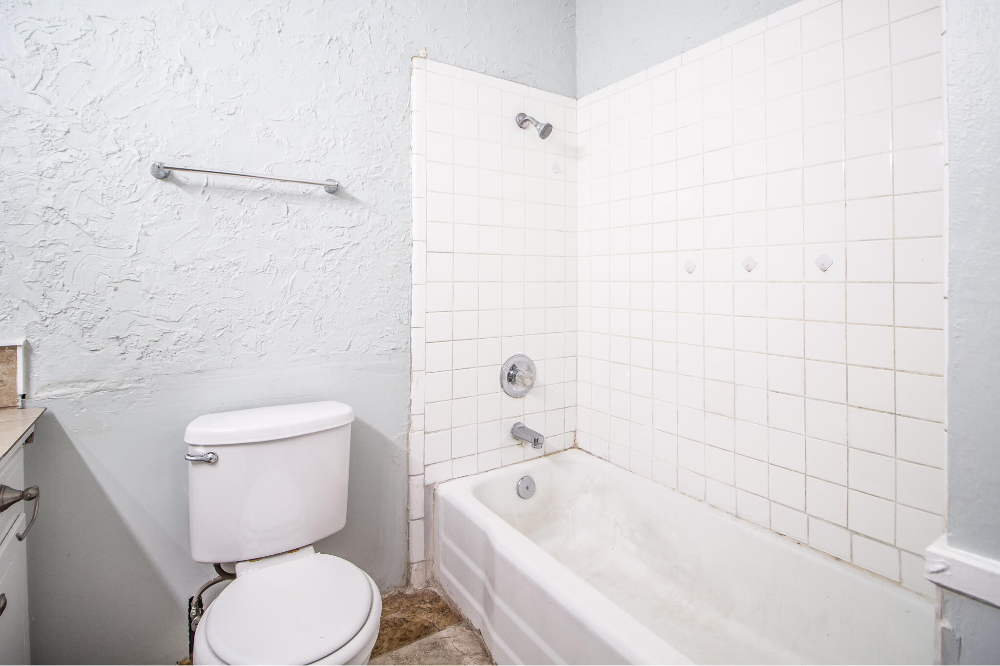 2101 49th Street Lubbock, TX 79412 - Photo 15 of 31 a bathroom with a toilet and bathtub