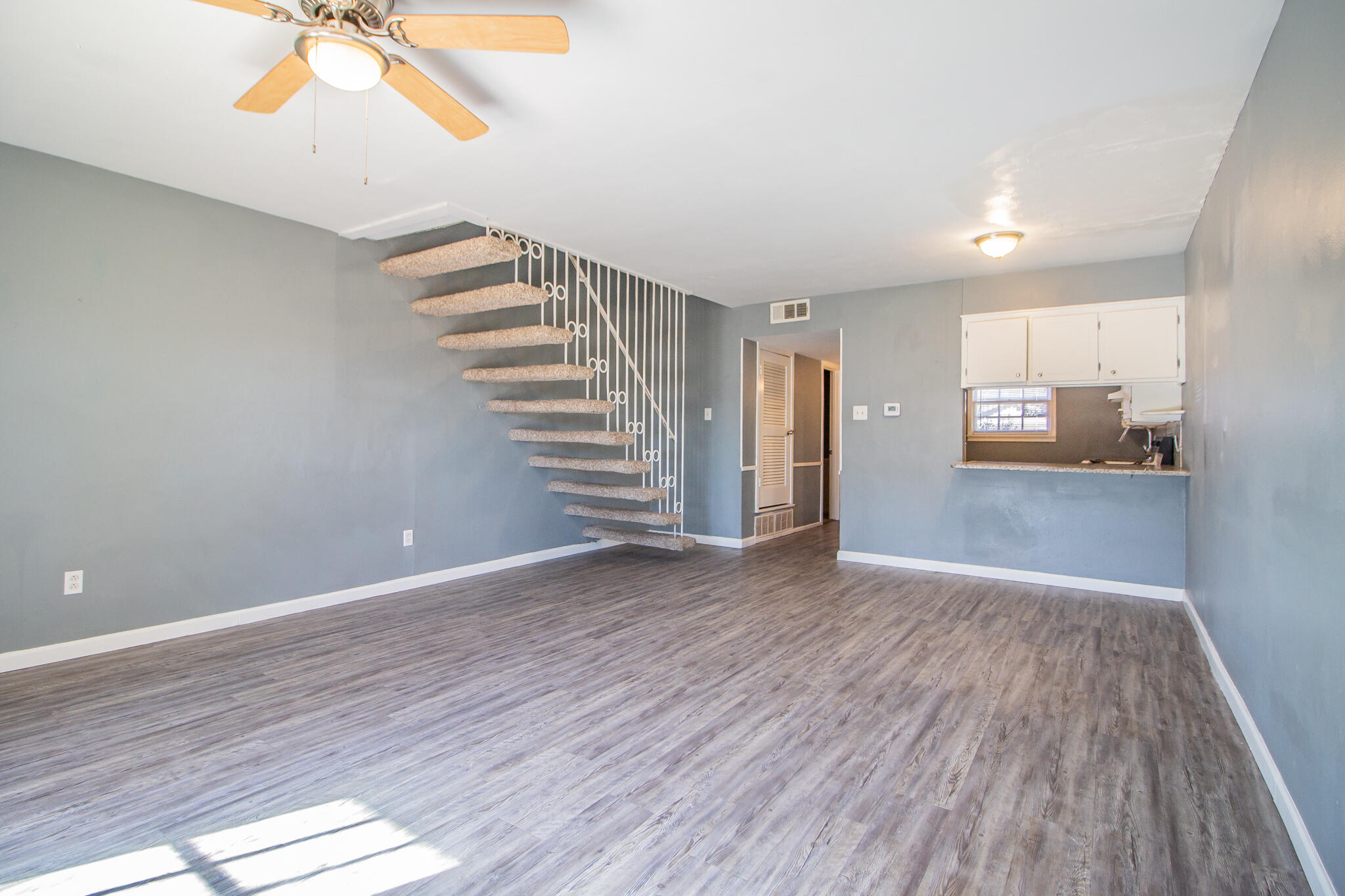 2101 49th Street Lubbock, TX 79412 - Photo 19 of 31 wooden floor in an empty room with a window