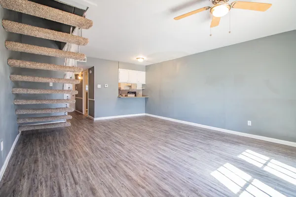 a view of empty room with wooden floor
