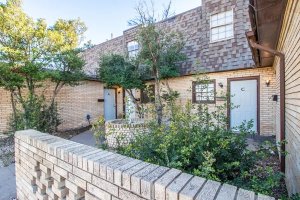 a couple of flower plants in front of house