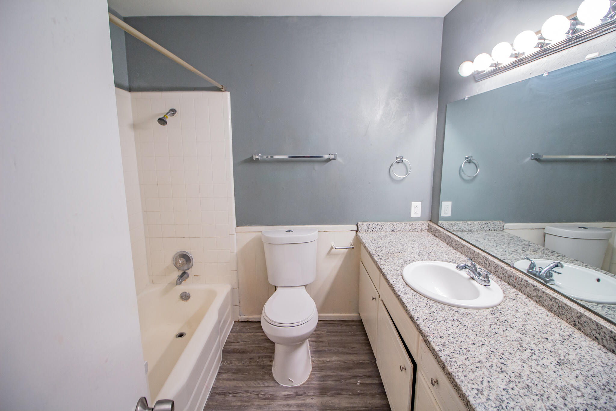 2101 49th Street Lubbock, TX 79412 - Photo 28 of 31 a bathroom with a granite countertop sink a toilet and a bathtub
