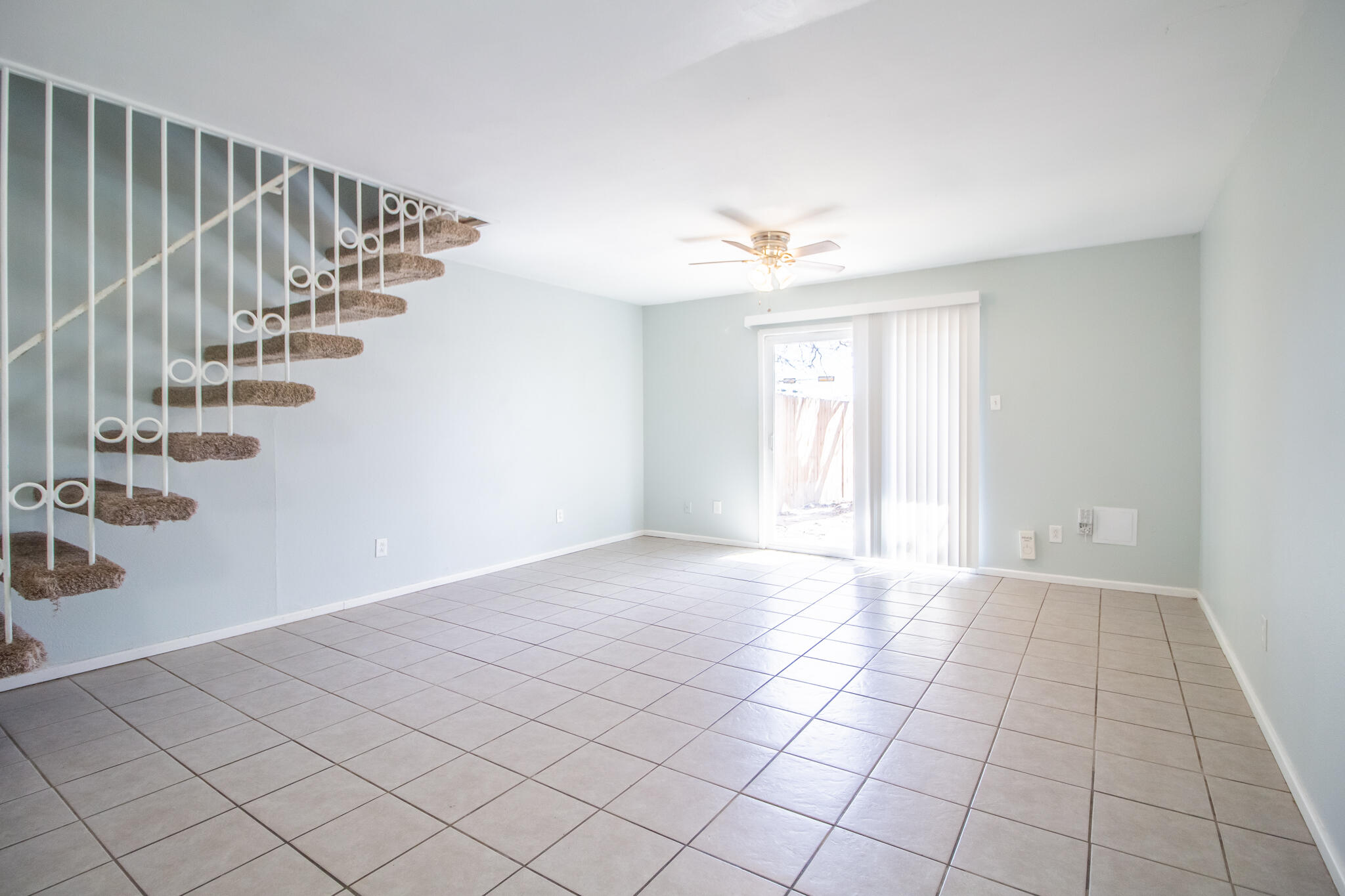 2101 49th Street Lubbock, TX 79412 - Photo 5 of 31 a view of an empty room with stairs and a chandelier