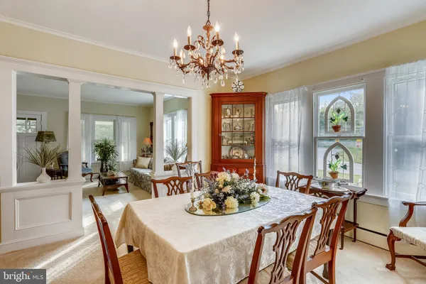 a view of a dining room with furniture and chandelier