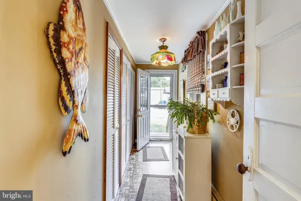 a view of a hallway with paintings on the wall