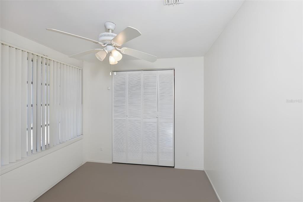 14451 Highland Road Wimauma, FL 33598 - Photo 60 of 80 an empty room with windows and fan