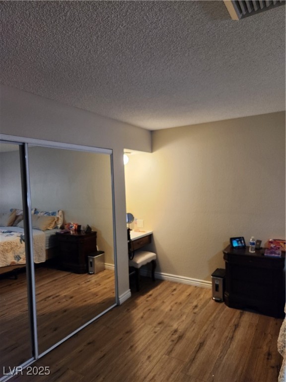 2645 South Lindell Road Las Vegas, NV 89146 - Photo 16 of 30 Bedroom featuring wood finished floors and a textured ceiling