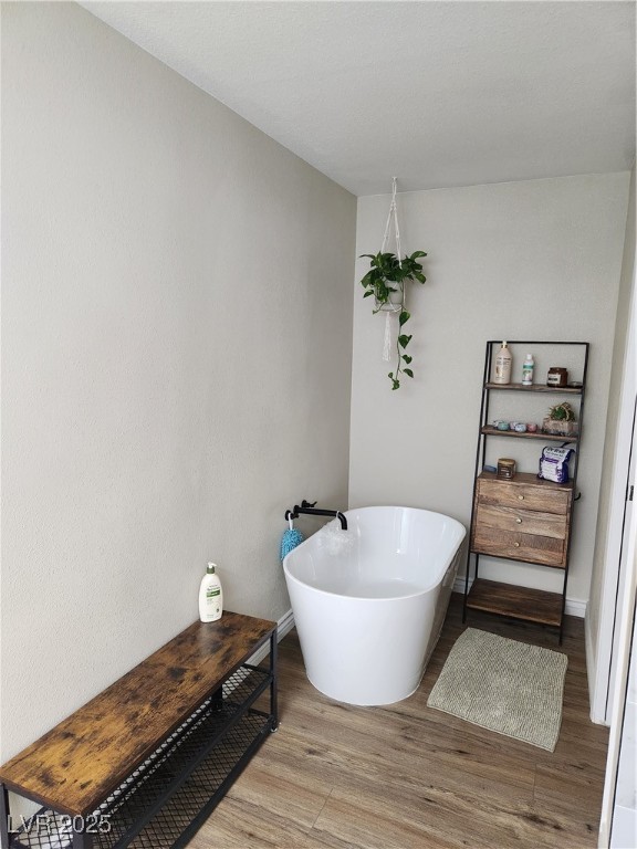 2645 South Lindell Road Las Vegas, NV 89146 - Photo 17 of 30 Full Bathroom with a freestanding tub and wood finished floors