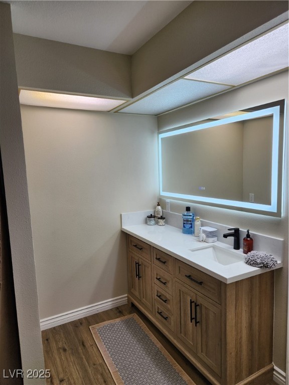 2645 South Lindell Road Las Vegas, NV 89146 - Photo 19 of 30 Bathroom featuring vanity and wood finished floors