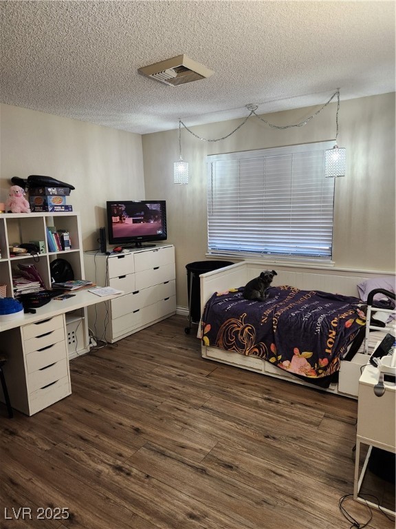 2645 South Lindell Road Las Vegas, NV 89146 - Photo 21 of 30 Bedroom 3 with dark wood finished floors, a textured ceiling, and an office area