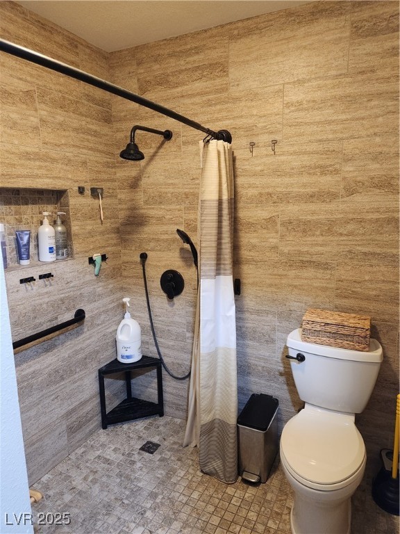 2645 South Lindell Road Las Vegas, NV 89146 - Photo 22 of 30 3/4 bathroom with tiled shower and tile walls Grab Bars