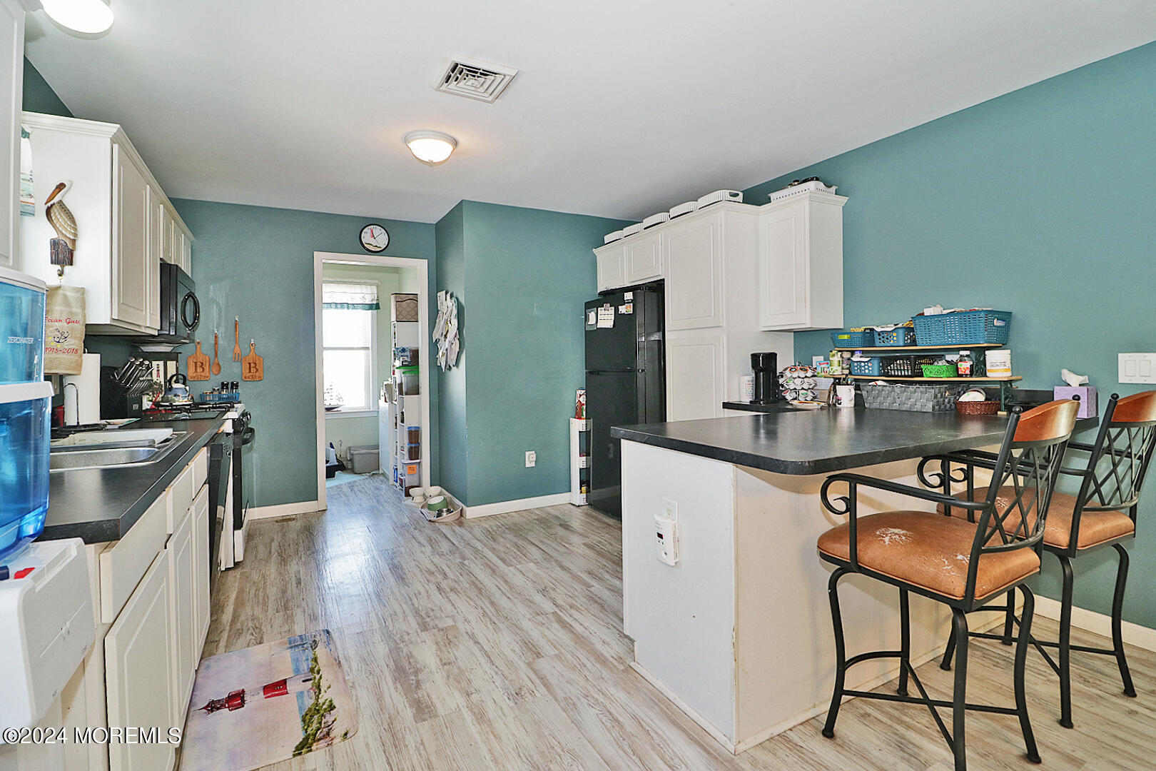 334 Bayview Avenue Ocean Gate, NJ 08740 - Photo 11 of 69 a kitchen with sink cabinets and wooden floor