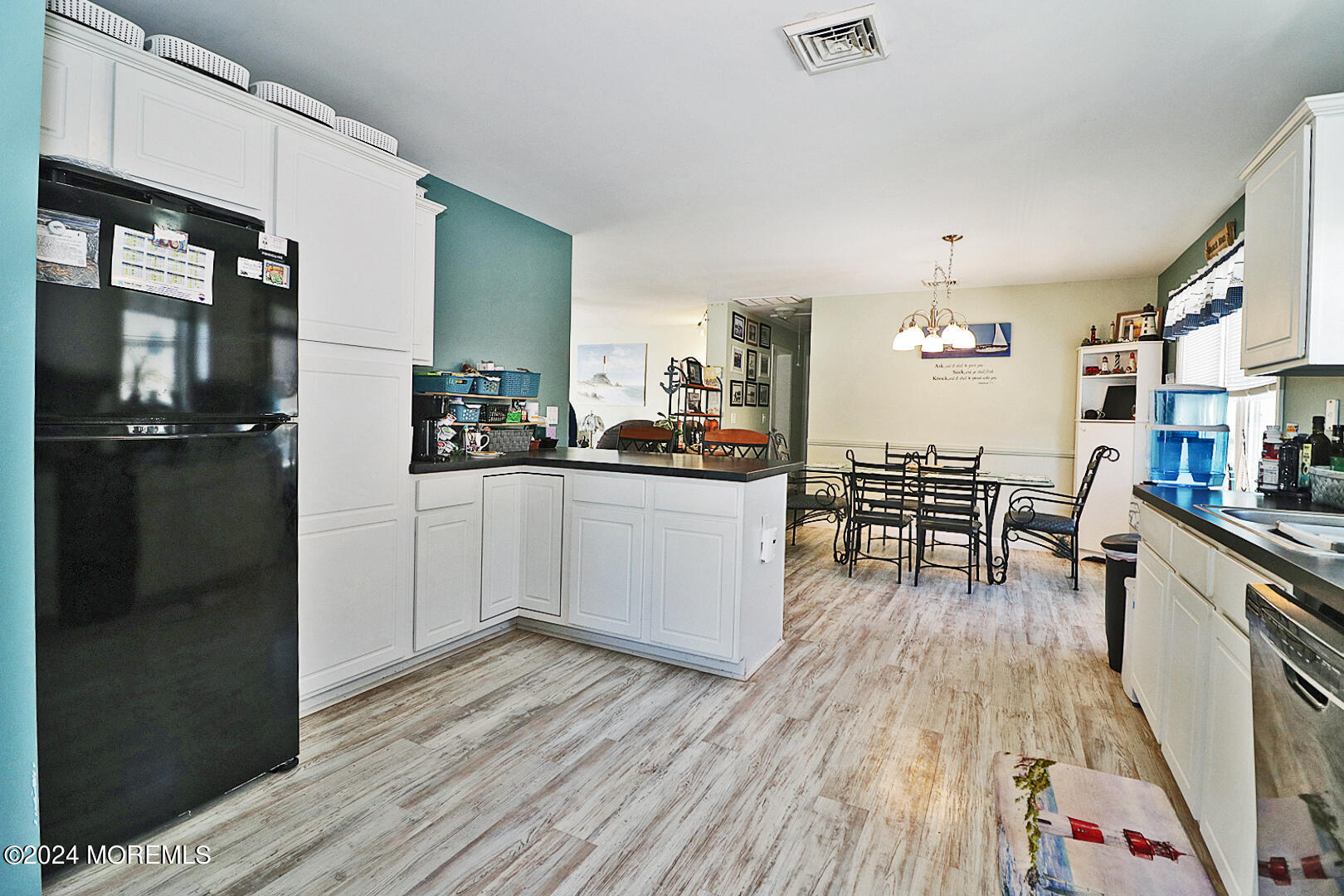 334 Bayview Avenue Ocean Gate, NJ 08740 - Photo 13 of 69 a kitchen with stainless steel appliances a dining table chairs stove and cabinets