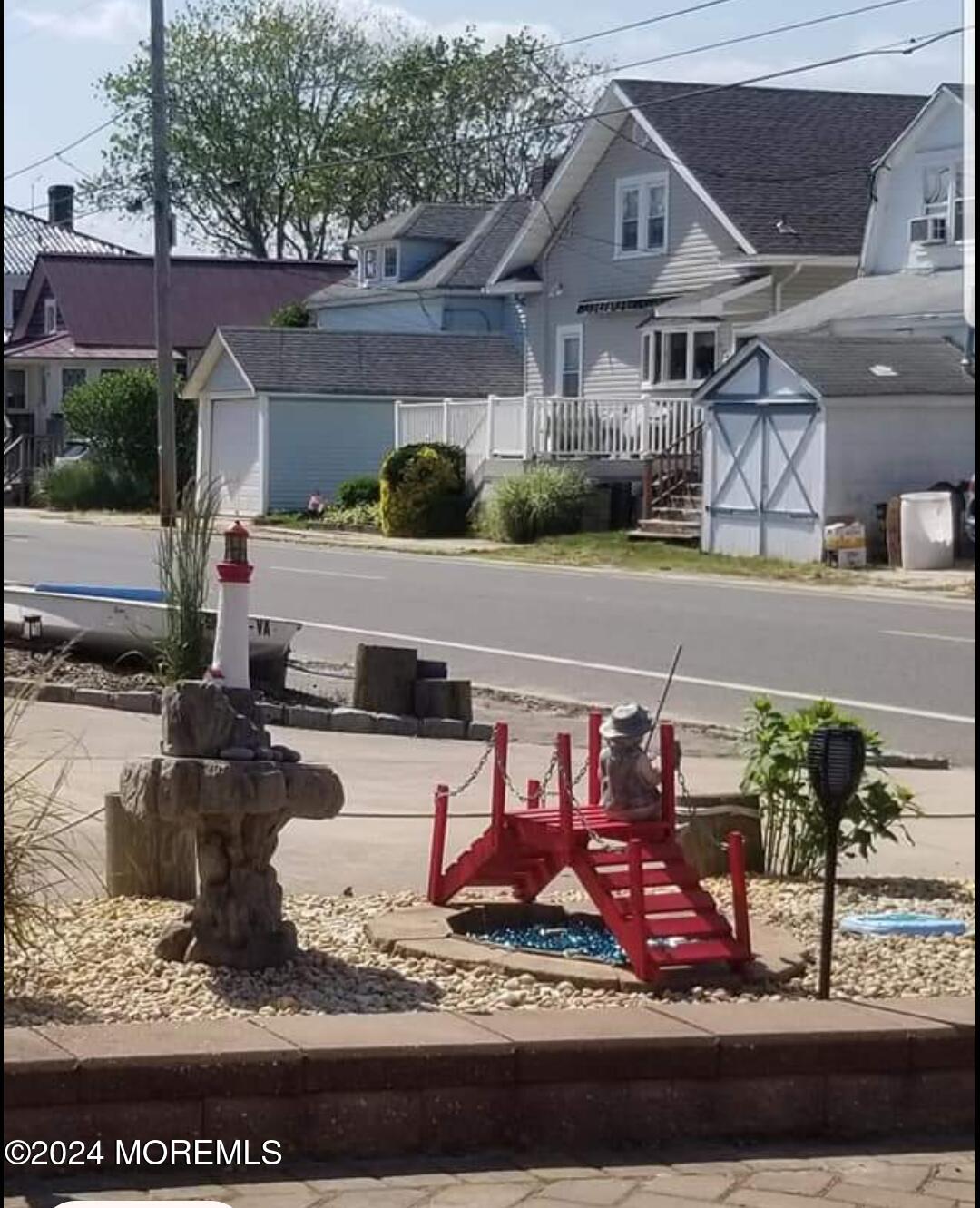 334 Bayview Avenue Ocean Gate, NJ 08740 - Photo 8 of 69 a view of a white house with large windows and a table