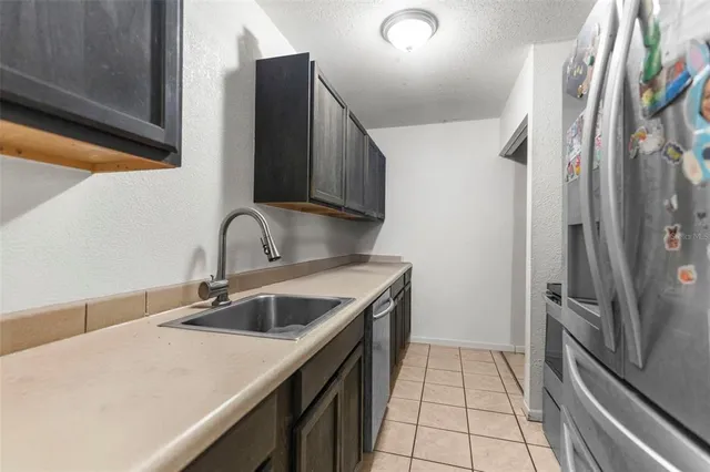 a kitchen with a sink and a refrigerator