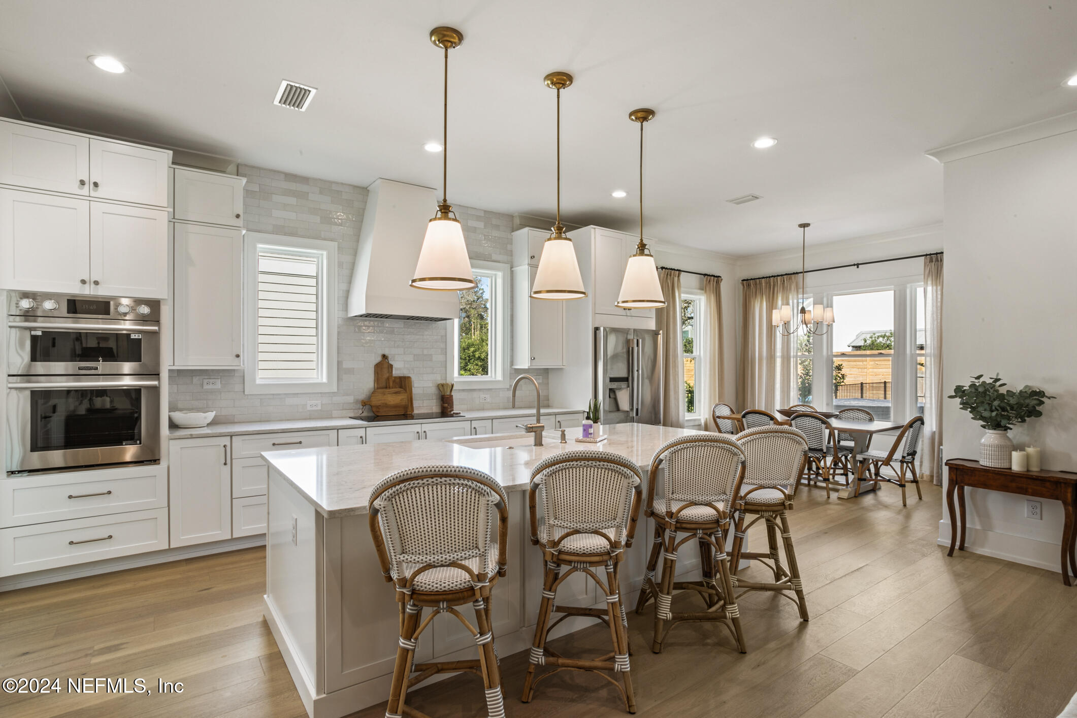 55 A Solana Road Ponte Vedra Beach, FL 32082 - Photo 15 of 42 a kitchen with stainless steel appliances granite countertop a table chairs stove and white cabinets