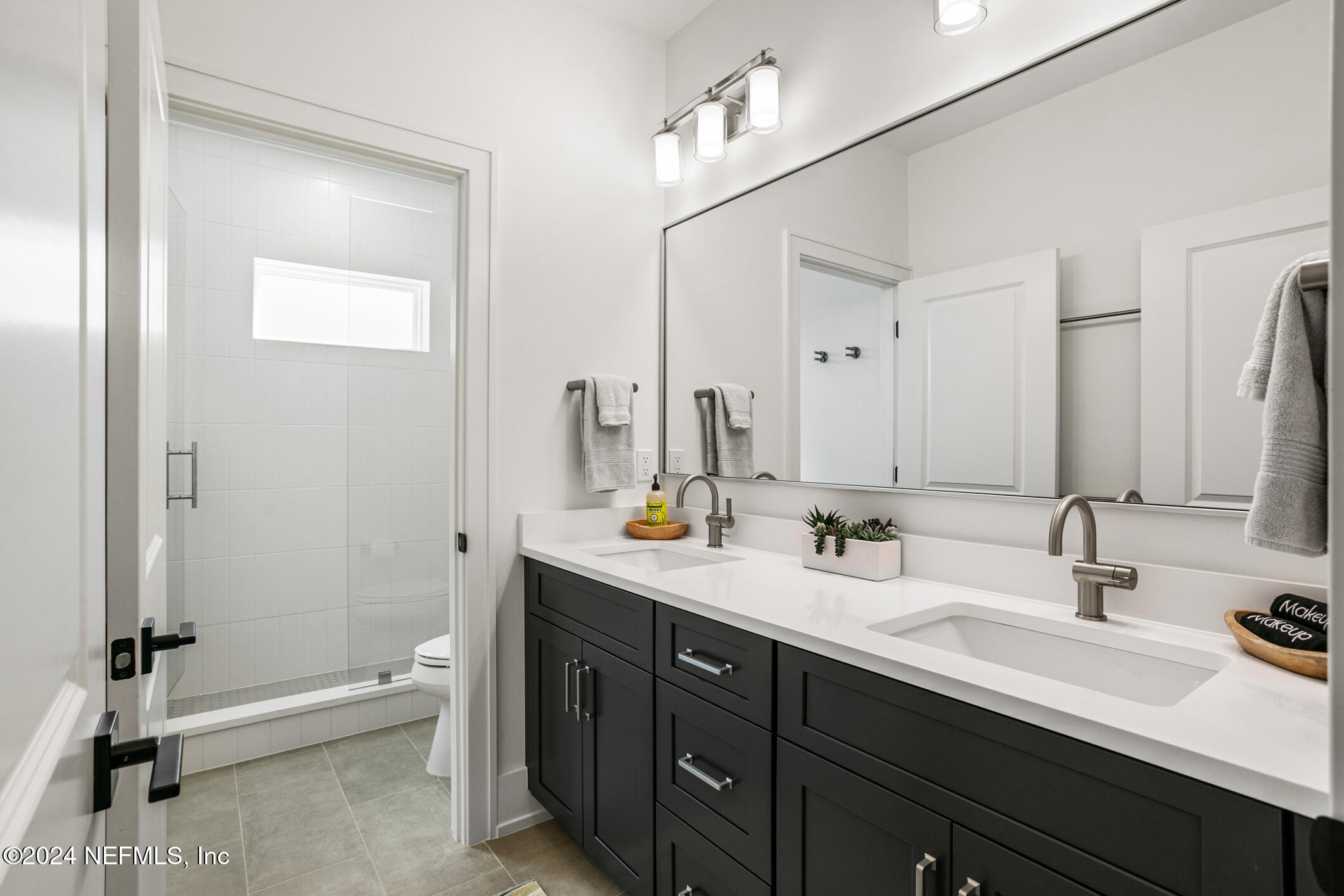55 A Solana Road Ponte Vedra Beach, FL 32082 - Photo 35 of 42 a bathroom with a double vanity sink and a mirror