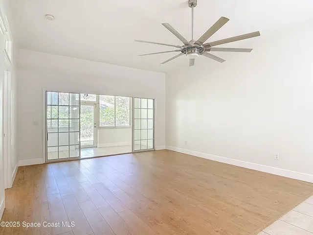 a view of a kitchen with a sink and a refrigerator