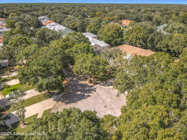 an aerial view of residential house with green space