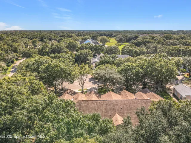 an aerial view of a houses with a yard
