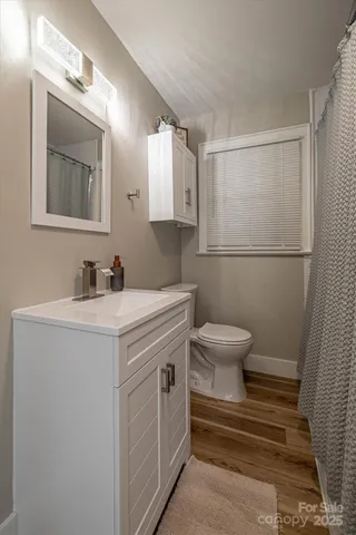 a bathroom with a sink toilet and mirror